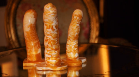 three silicone dildos in gold and white marbelling