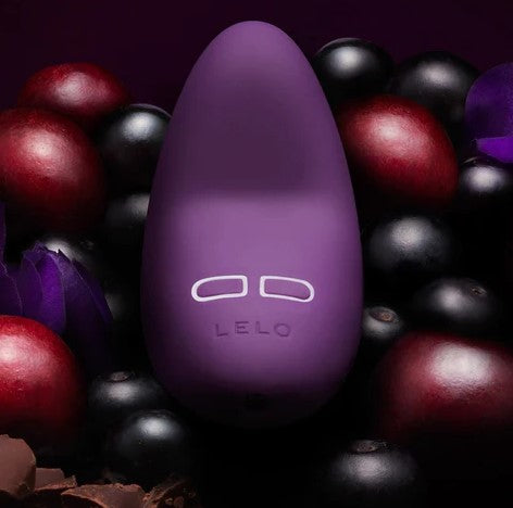 Lelo Lily 2 vibrator in dark purple on a background of dark berries