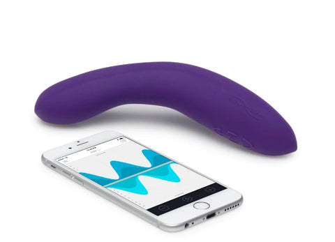 A purple G-spot vibrator next to a smartphone