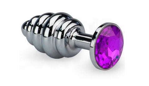 A stainless steel butt plug with ridges and a purple jewel in the base