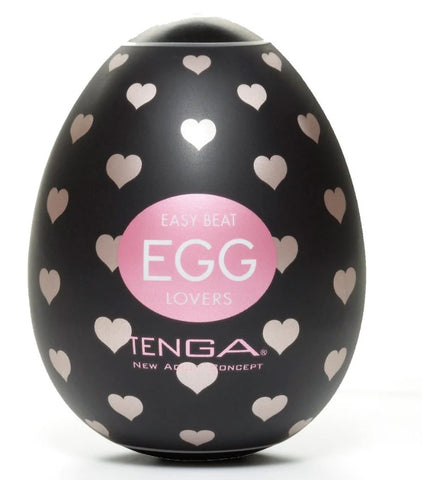 A black Tenga egg with pale pink hearts on the wrapping