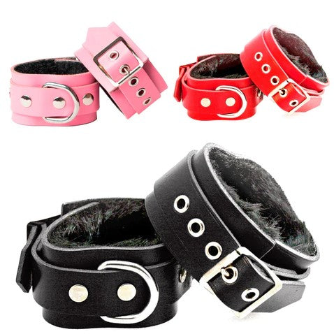 Three pairs of handmade leather wrist cuffs in black, red and pink