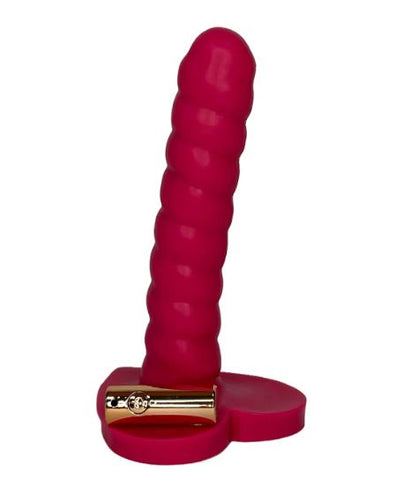 A thin pink dildo with ribbed shaft and heart-shaped base. A small bullet vibrator in gold is laying on the base. 