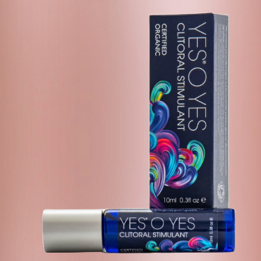 A bottle of Yes O Yes Rollerball Clitoral Stimulant Oil next to itsbox