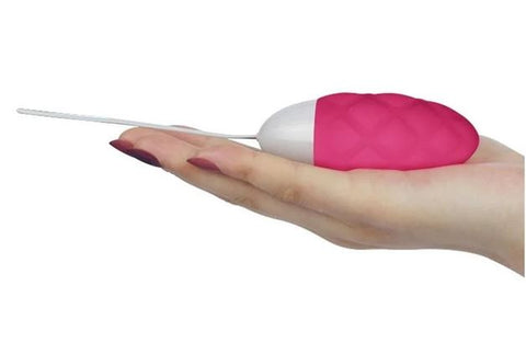 A hand holding an Ijoy vibrating egg in pink