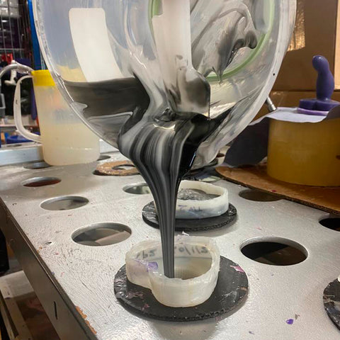 white and black silicone being poured into a mould