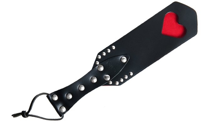 Spanking paddle with cut-out heart in black and red