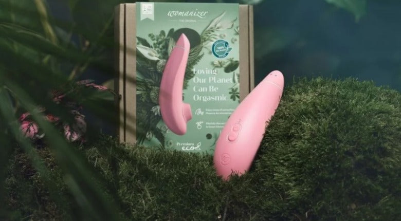 womanizer eco in light pink surrounded by greenery