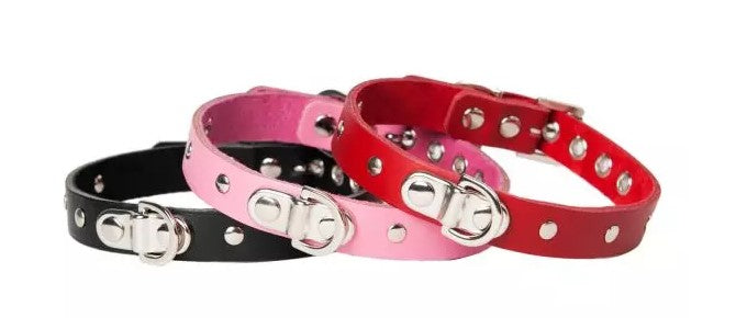 slim bondage collars in black, read and pink leather. Decorated with silver studs and a D-ring.