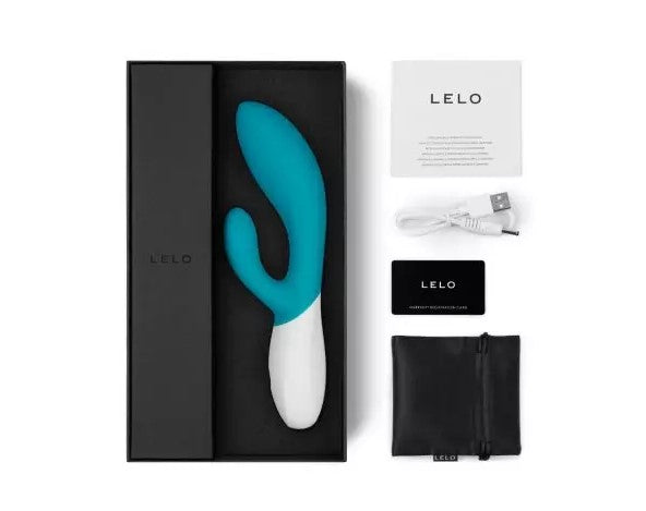 Lelo Ina dual vibrator in turqouise silicone and white ABS plastic, in a black gift box. The box is surrounded by a sachet or lube, a stiorage bag, charging cable and an instruction leaflet.