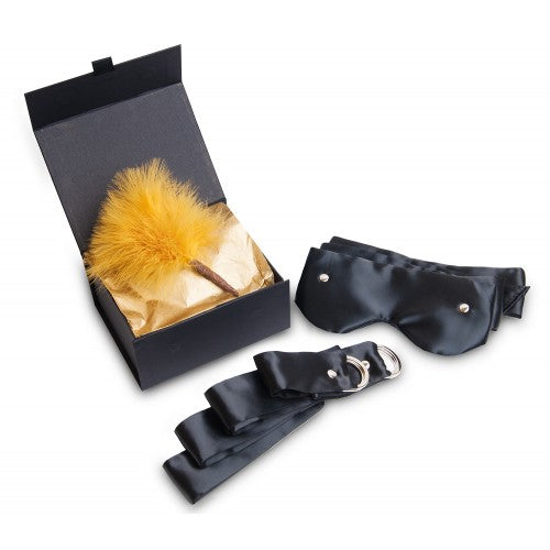 black box with black blindfold, black satin cuffs and a sofy feather pom in gold