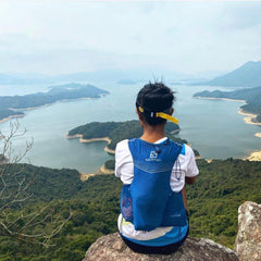 Woman at top of mountain looking at beautiful view of Hong Kong oceans