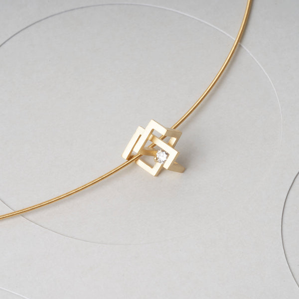 K18 diamond pendant By-Pass. It has a modern, geometric design by japanese jewelry brand MENTOSEN.