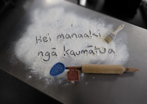 hei manaaki nga kaumatua written in flour
