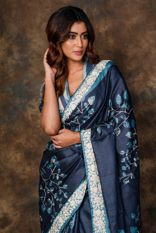 A woman wearing midnight blue pure tussar printed saree