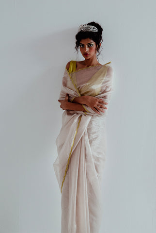 A woman wearing pure silver tissue saree