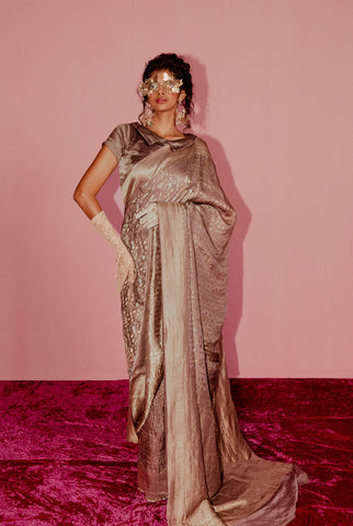 A woman wearing lilac pure crepe saree