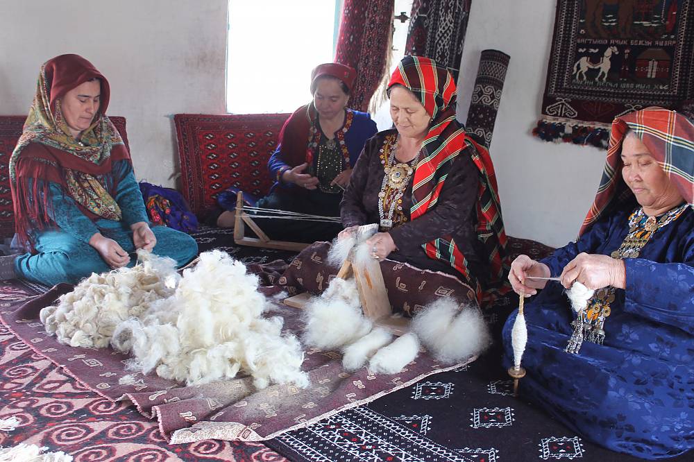 Women in Turkey shearing Angora goat hair, working on a loom to hand weave a vintage rug