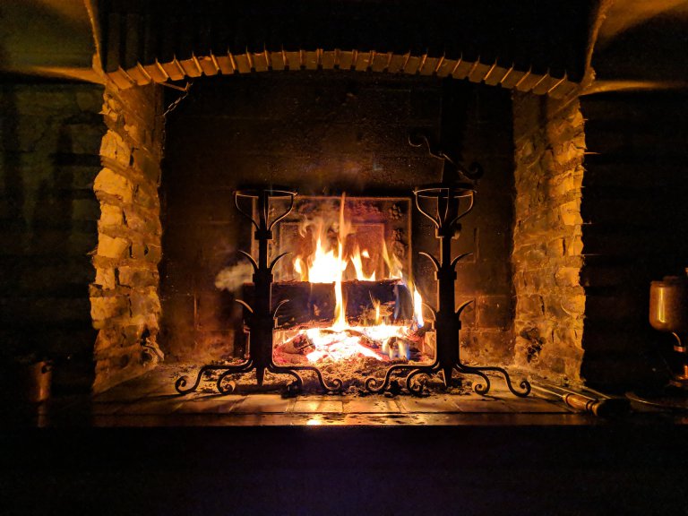 A fireplace putting out warmth during the colder months.
