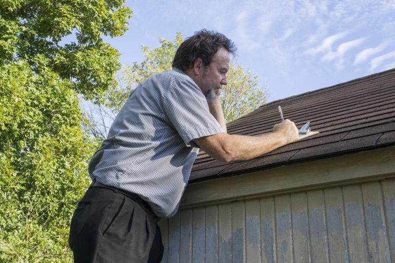 A man inspecting a roof for damage.