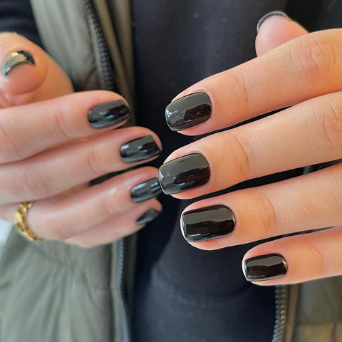 Liquorice black nail polish on a manicured hand