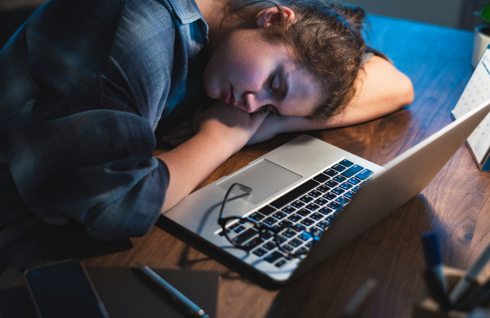 Girl falling asleep doing homework