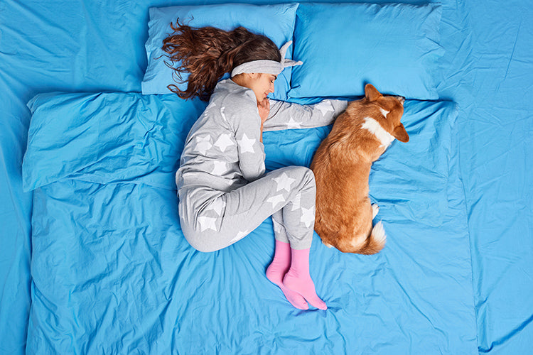 Girl sleeping with pet dog