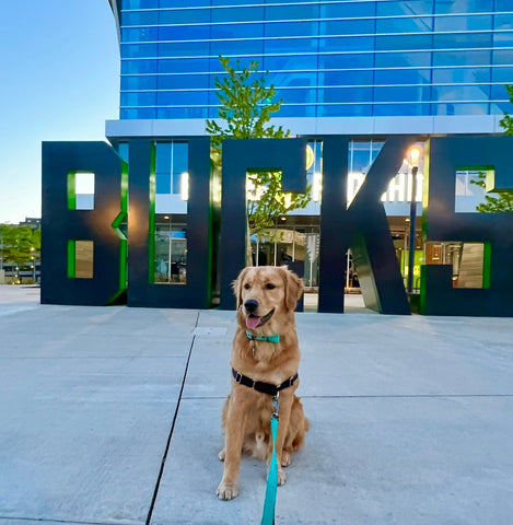 Cash with the Milwaukee Bucks sign