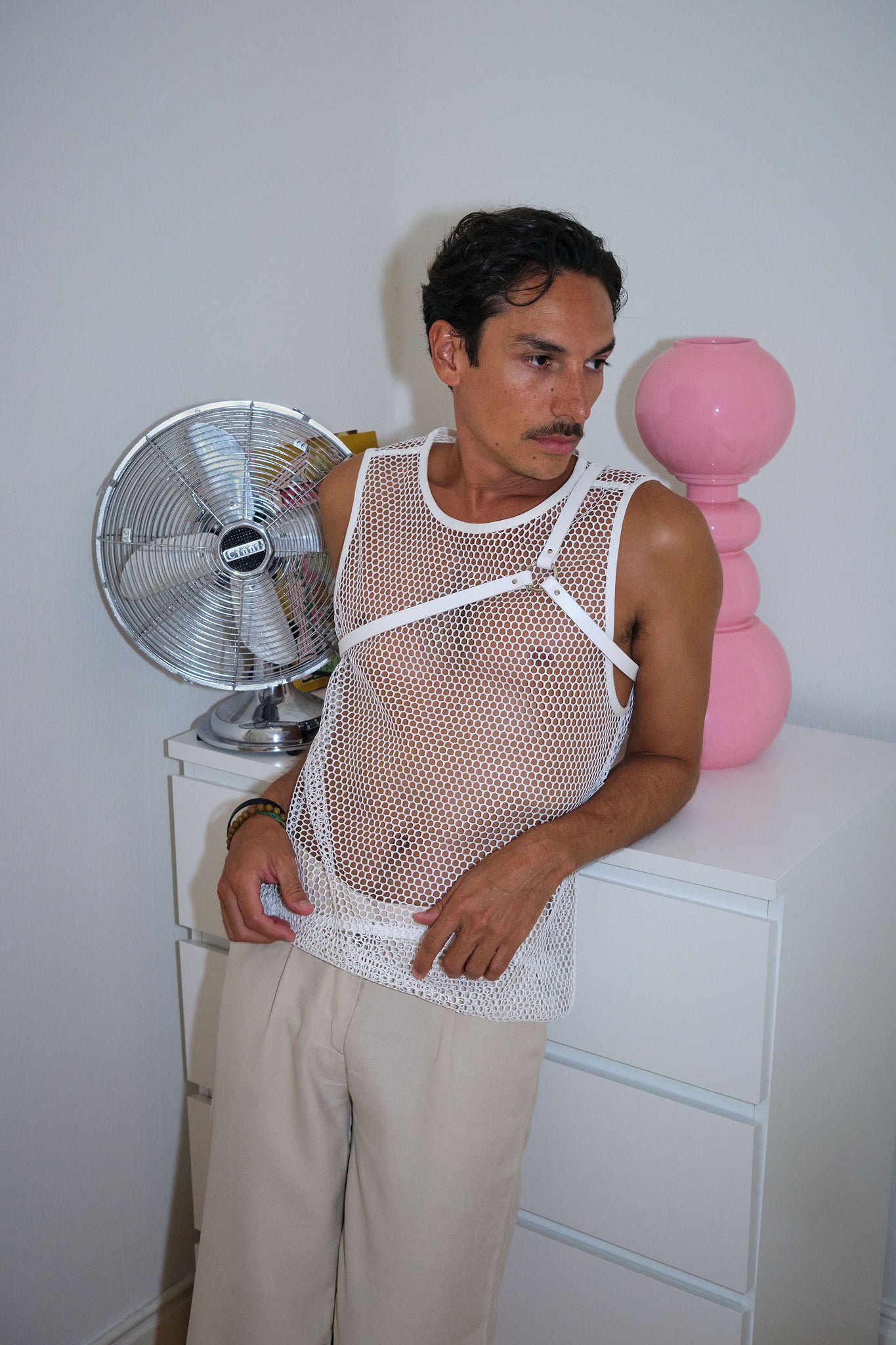 man wearing white yvy leather asymmetric shoulderpiece and net vest