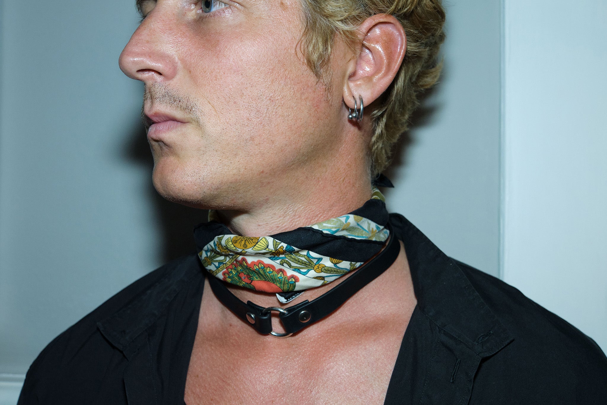 closeup of man wearing yvy leather black ring choker with scarf