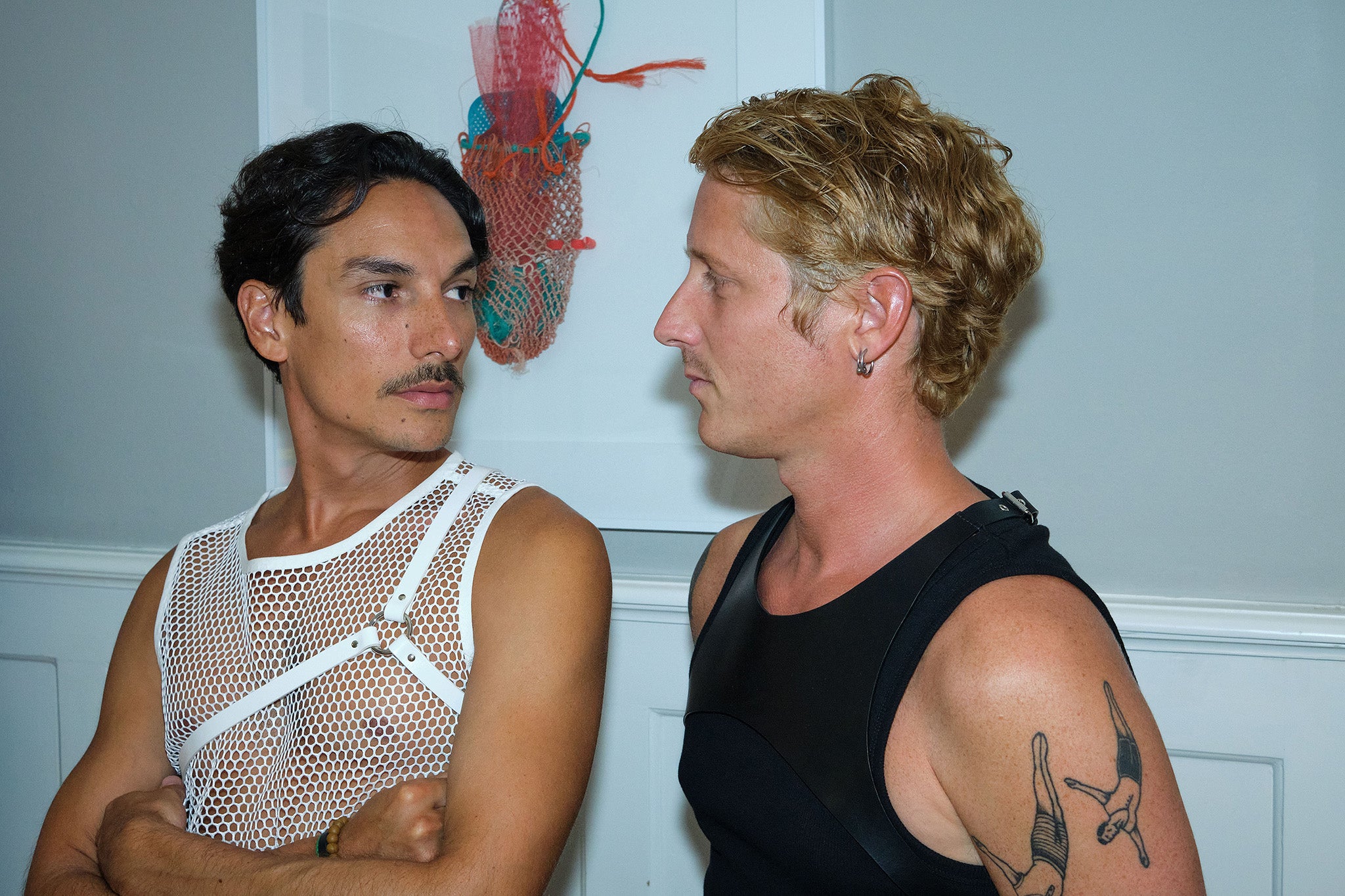 two men wearing yvy leather shoulder pieces with tank tops