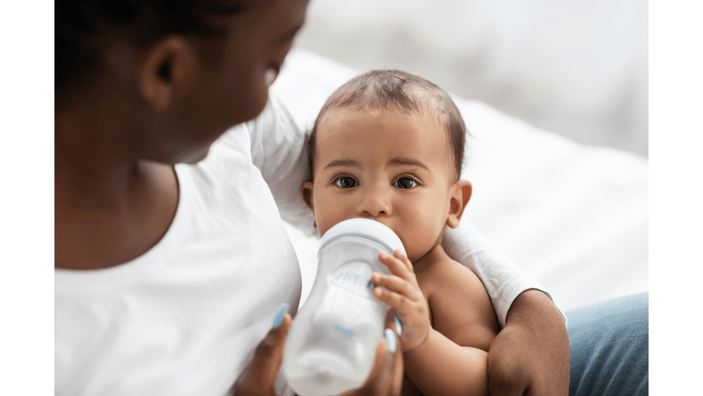 Mother bottle feeding a baby