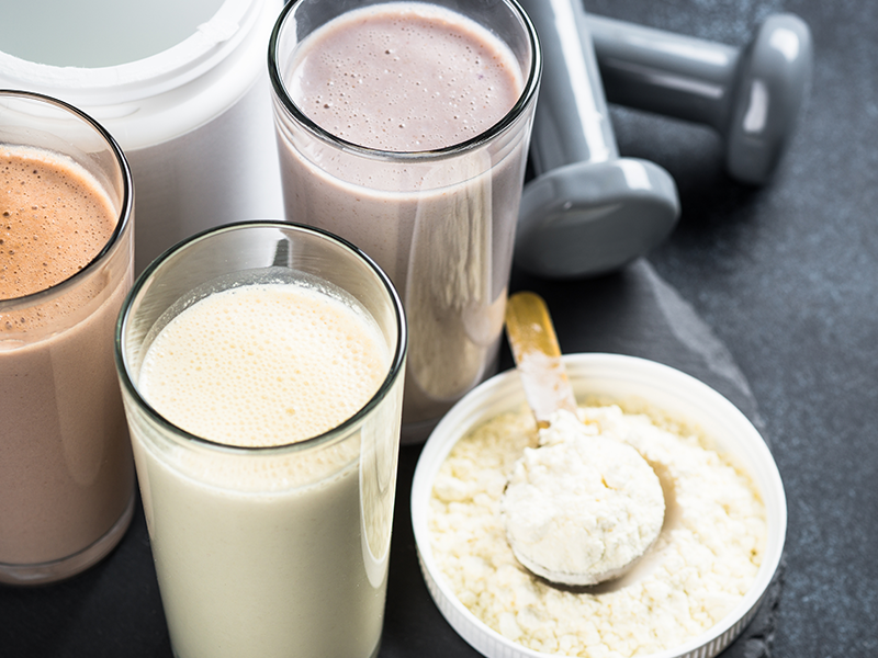 Glasses of protein shakes and powder