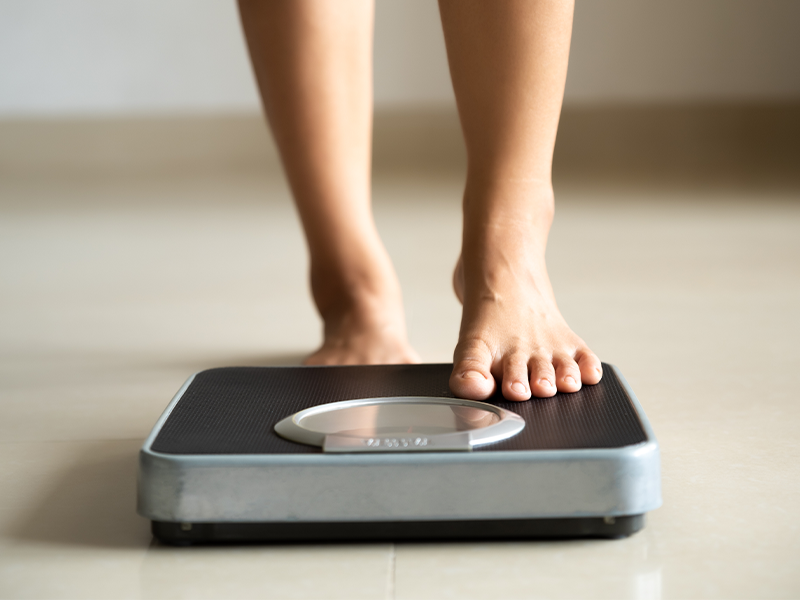 Woman on body weight scales