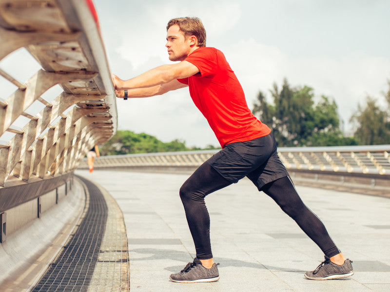 Man does standing calf stretches