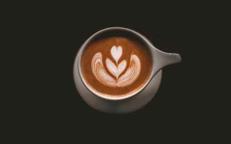 A mug of espresso coffee and milk with latte art