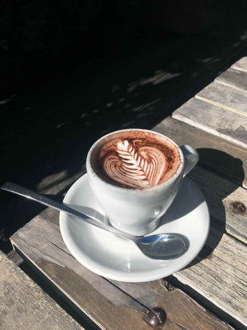 Caffeine in medium roast cup of coffee with latte art