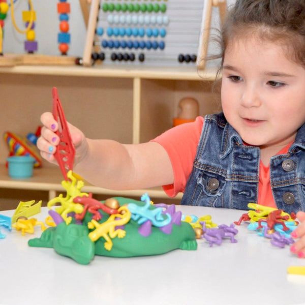 Child playing Dreaming Dragon a colorful fine motor skills game for early childhood development. This game helps educators use Developmentally Appropriate Practice for child-led learning.