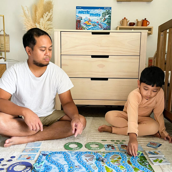Father assessing son's math skills using developmentally appropriate practice and play-based education.