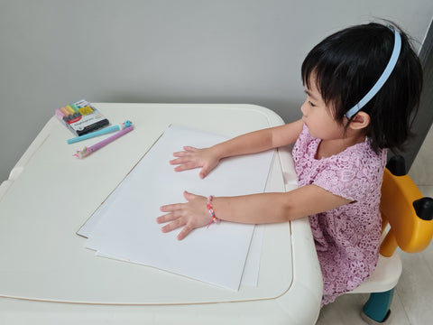 kid hands on paper