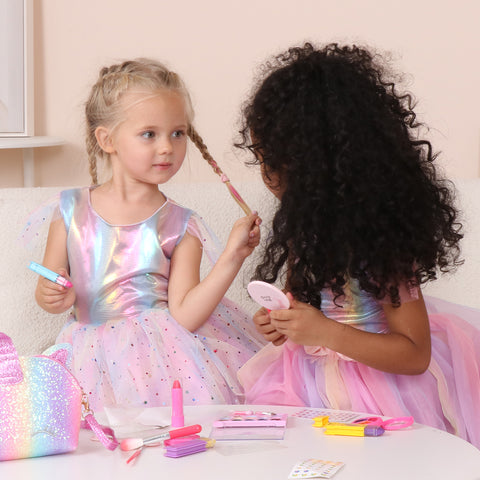 Young girls play with makeup toys