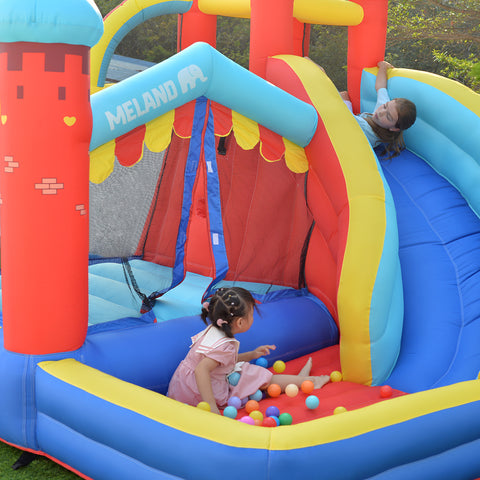 Girls play on bounce house