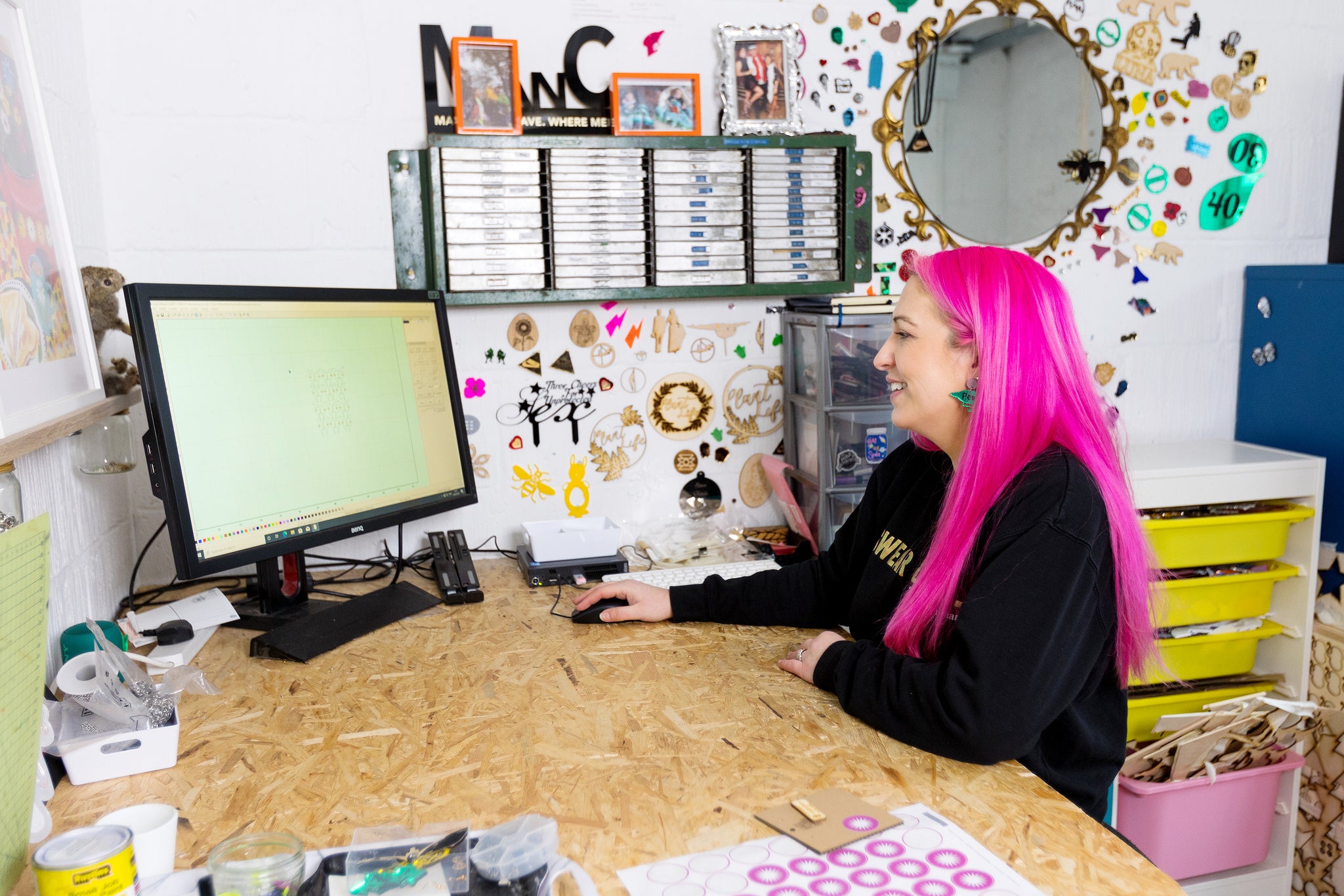 Jody Appleton working at her computer on a commission laser cut piece 