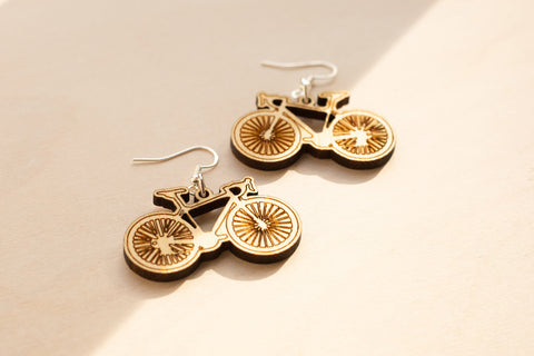 Laser engraved and laser cut bamboo earrings in the shape of road bikes on sterling silver ear wires