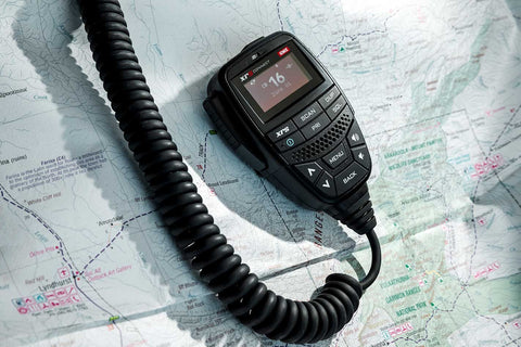 Get a clear look at the essential tool for off-road communication. This image showcases a UHF radio with clearly labeled channels and buttons.