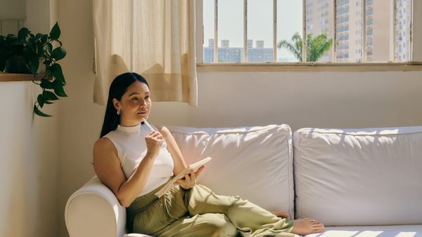 Woman sitting writing a letter to herself