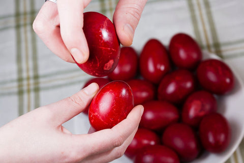 cracking red eggs for Greek Easter