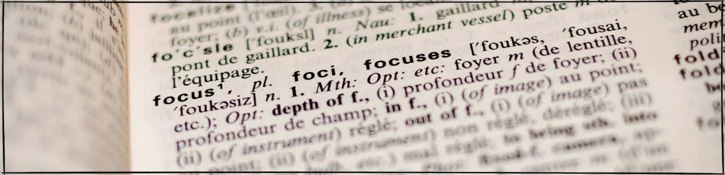 the word 'focus' shown on the page of a dictionary and photographed in a shallow depth of field