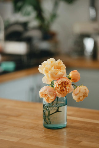 Roses sitting in a vase on a table
