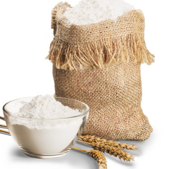 einkorn wheat flour in a brown sack and in a glass bowl, with einkorn berries on the sie